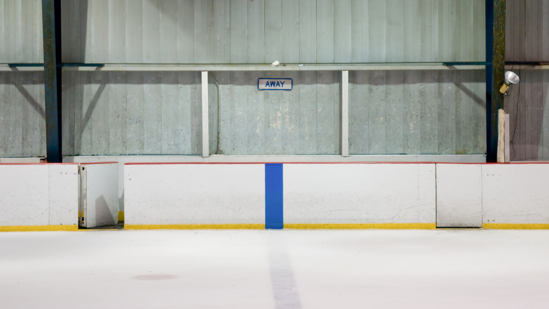 An empty hockey net on a deserted rink